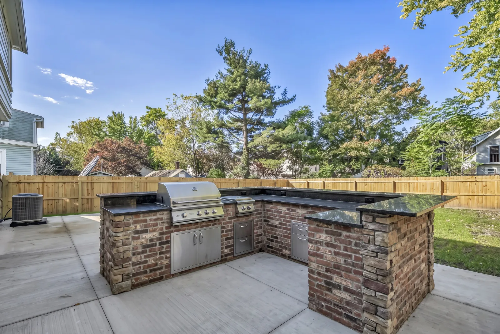 The same patio with an AI-designed brick outdoor kitchen